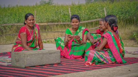 Women in Traditional Attire Gathered Outdoors in Rural India